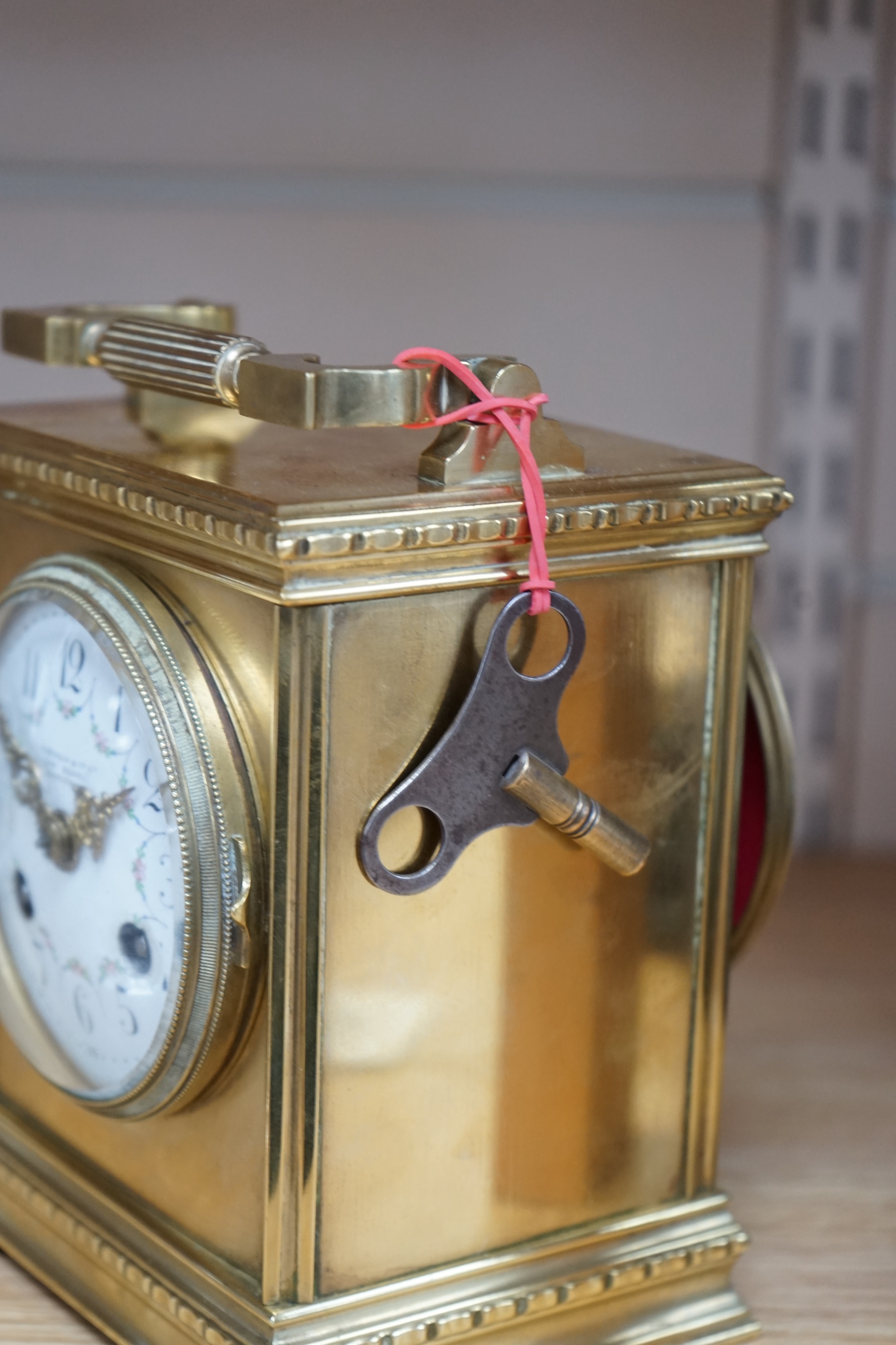 A late 19th century French brass large carriage clock with convex enamel dial, retailed by Robinson & Co. with key, 17cm. Condition - fair to good, not tested as working